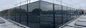 Vertical wall mounted solar water heater panels for a commercial swimming pool