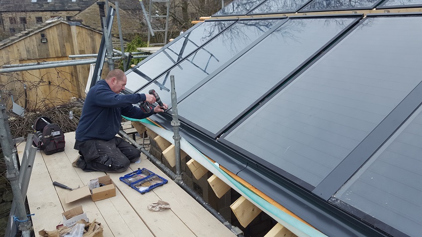 Connection clamps being secured to solar panels